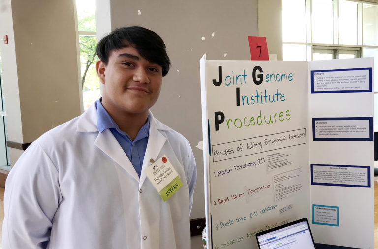 an intern next to posterboard