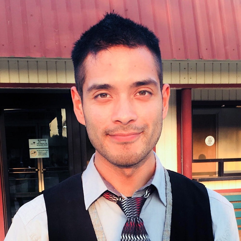 an intern standing in front of a building