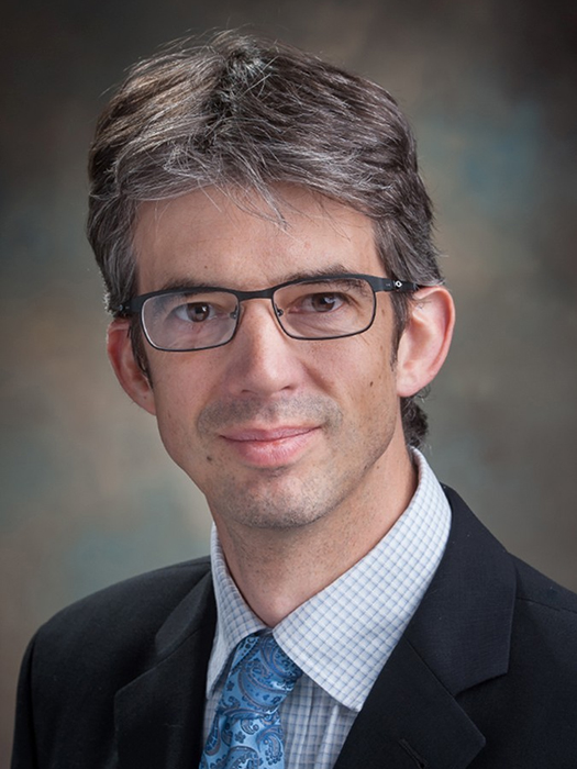 Headshot of a researcher wearing glasses