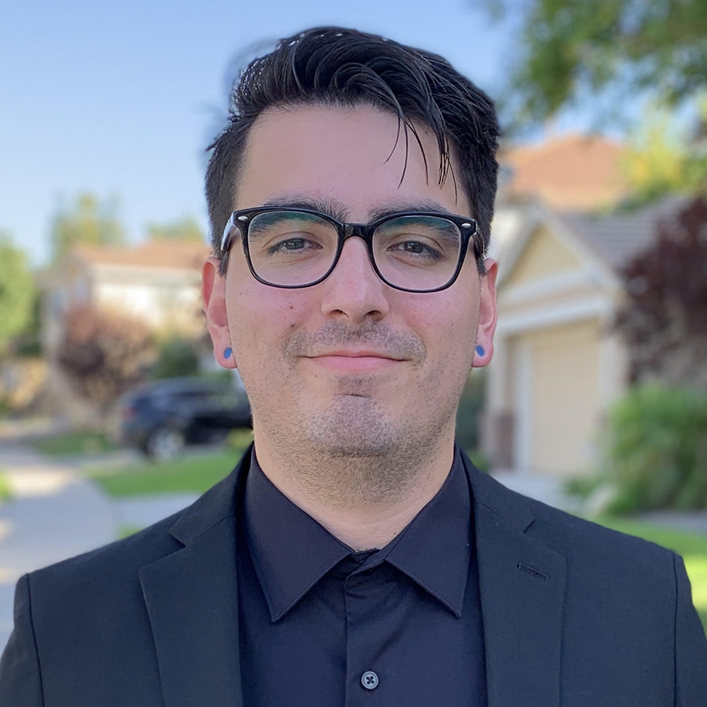 an intern standing in front of a house with the background blurred