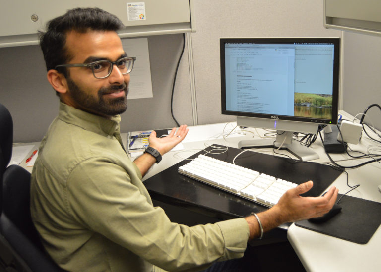 an intern looking over their shoulder at their desk