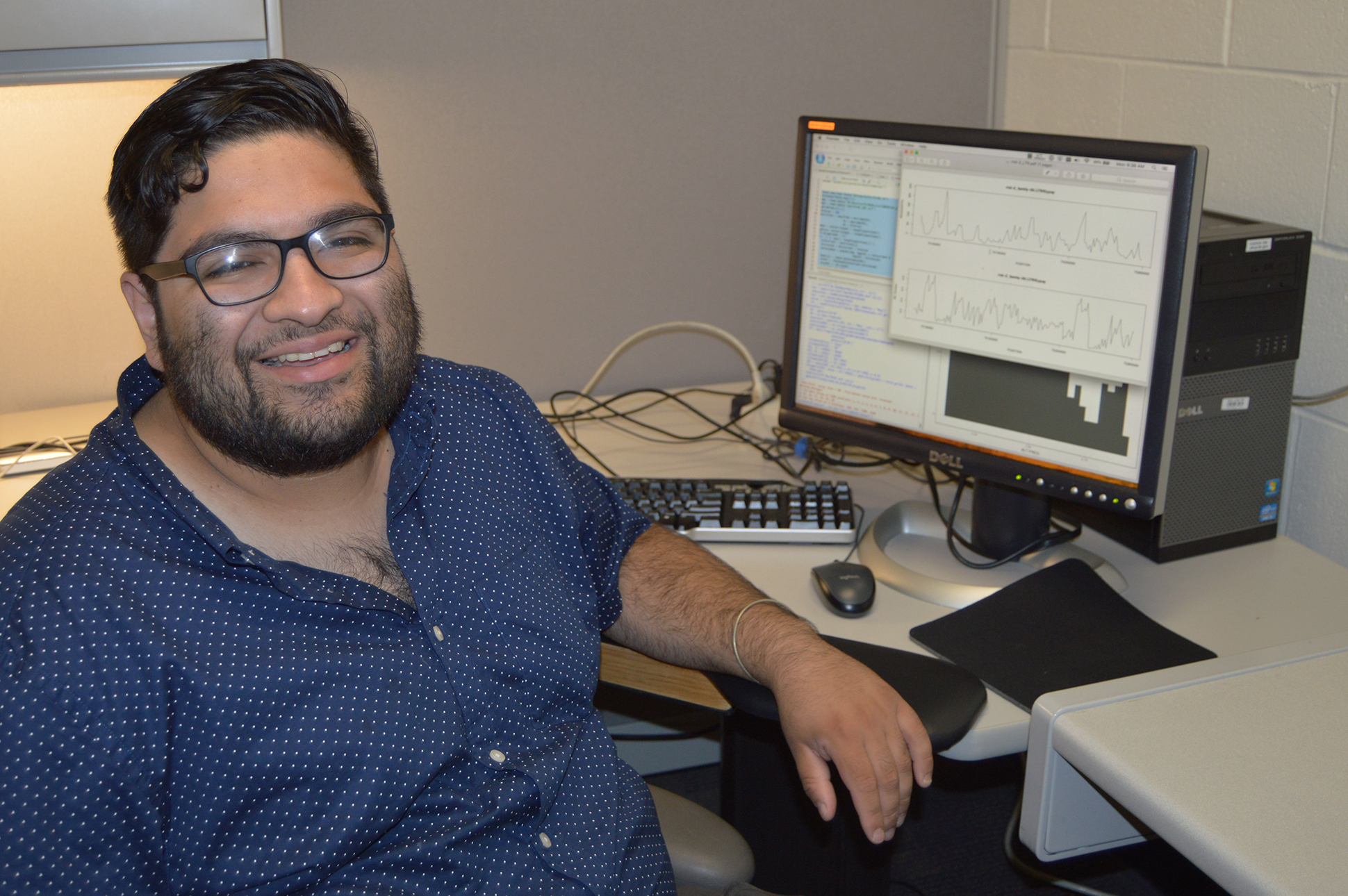 an intern sitting at their desk smiling for a photo