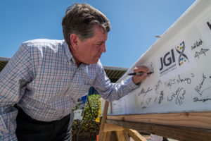 person signing a beam