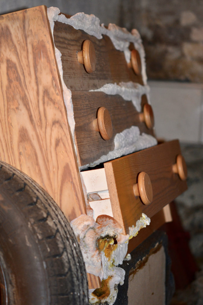 a wooden dresser with dry rot on it