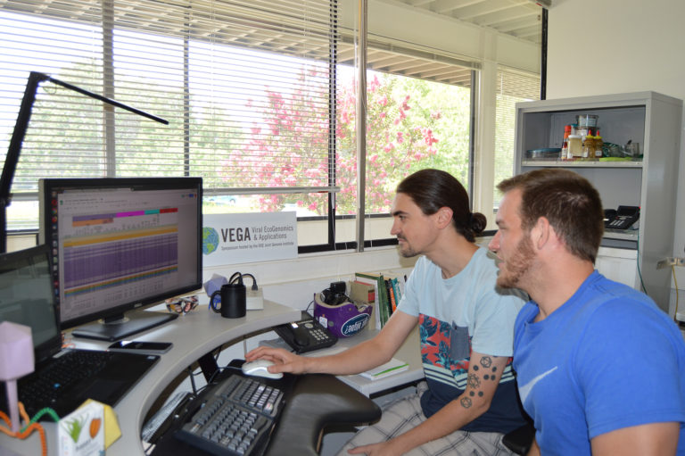 two scientists working at a computer