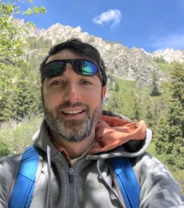 a person taking a selfie in a mountain wooded area 