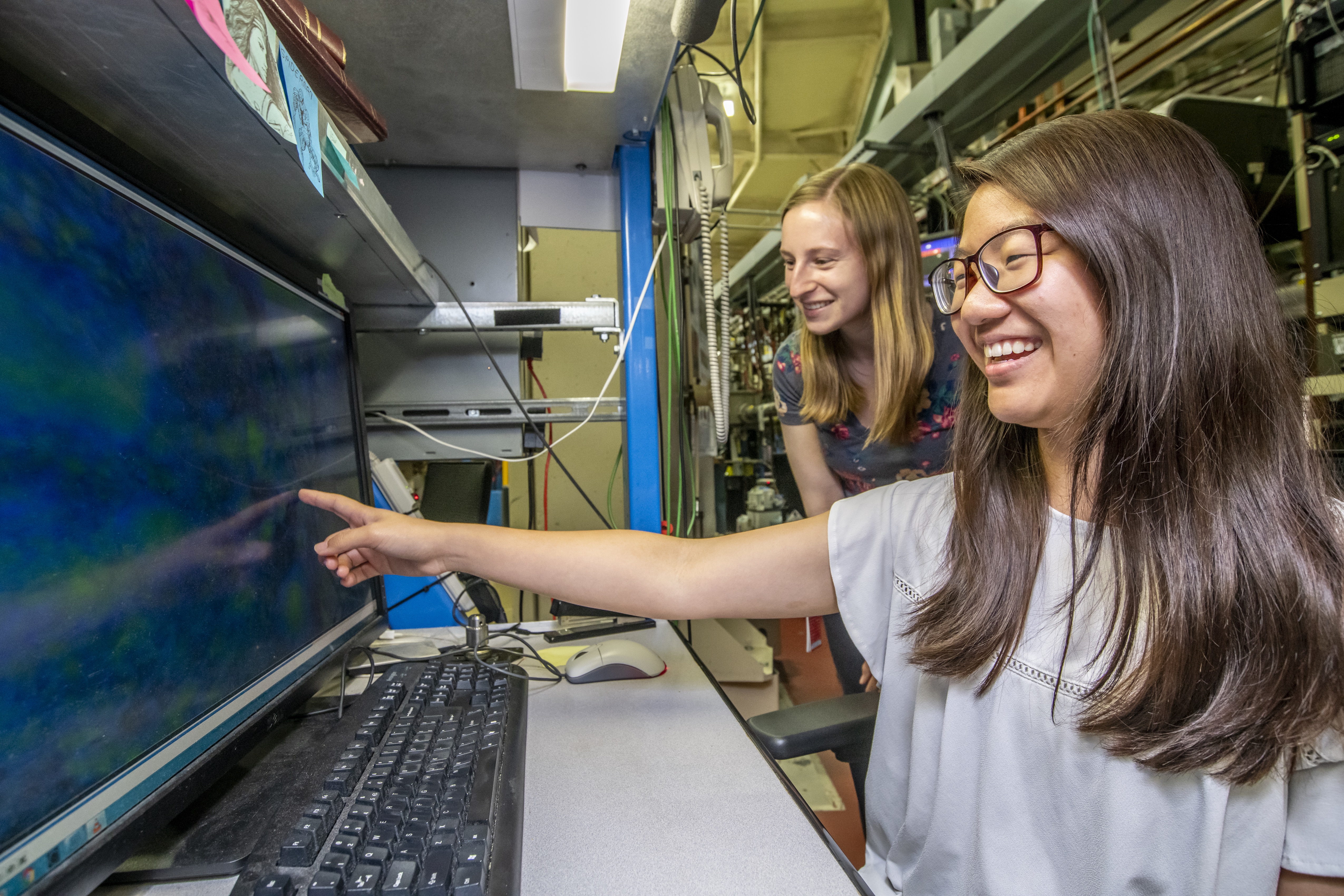 An intern and mentor looking at a computer screen