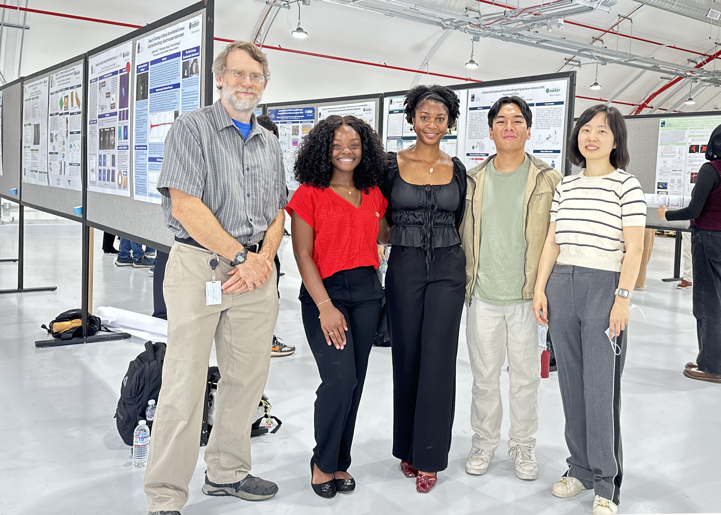 AAMU interns standing with their mentors with posters behind them