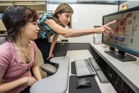 two people looking at a computer