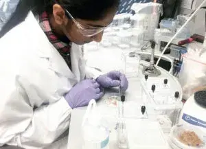 a person in lab gear working