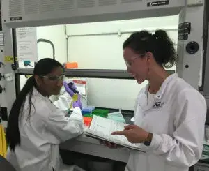 two people in lab gear working