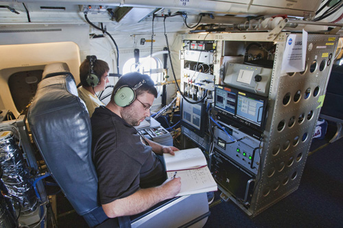 Photo: Terry Lathem, a graduate student in Georgia Tech’s School of Earth and Atmospheric Sciences, takes notes aboard a NASA DC-8 gathering samples of microorganisms in the atmosphere. Credit: NASA