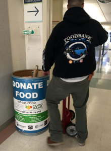 A Contra Costa Food Bank employee collects the last of the barrels at the JGI on the last day of the 2014 Holiday Food Drive