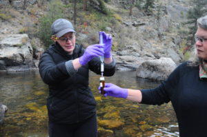 LeAundra Schopflin, grad student at Colorado State University, Fort Collins, sampling the Cache la Poudre river in 2019. (Massie Ballon)