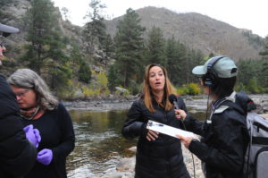 Kelly Wrighton, microbial ecologist at Colorado State University, Fort Collins, on the Cache La Poudre river being interviewed by host Alison Takemura. (Massie Ballon)