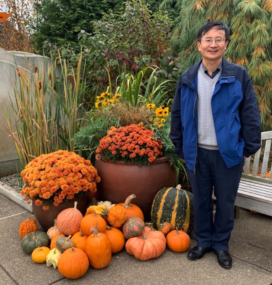 Hong Ma, plant biologist at Penn State University, is working to understand the evolution of land plants. The gourds beside him are an example of their richness. (Alison F. Takemura)