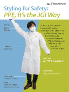 Masked female researcher poses wearing lab personal protective equipment (PPE)