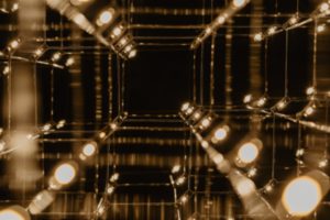 Abstract image of gold lights and squares against a black backdrop