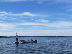 A sunny, blue-sky day at Lake Mendota with a boat tied to a buoy